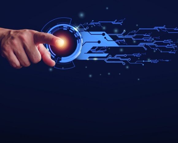 Eine Hand streckt einen Finger aus, um eine leuchtende digitale Schnittstelle mit nach außen strahlenden blauen, schaltkreisähnlichen Mustern auf einem dunklen Hintergrund zu berühren, die Technologie und Konnektivität inmitten sich entwickelnder IT-Sicherheitstrends symbolisieren.