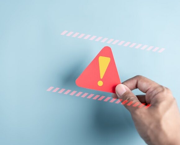 System-Warnung mit rotem Dreieck in Hand