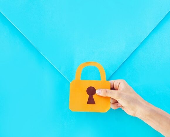 Briefumschlag, davor Hand mit Datenschutz-Symbol