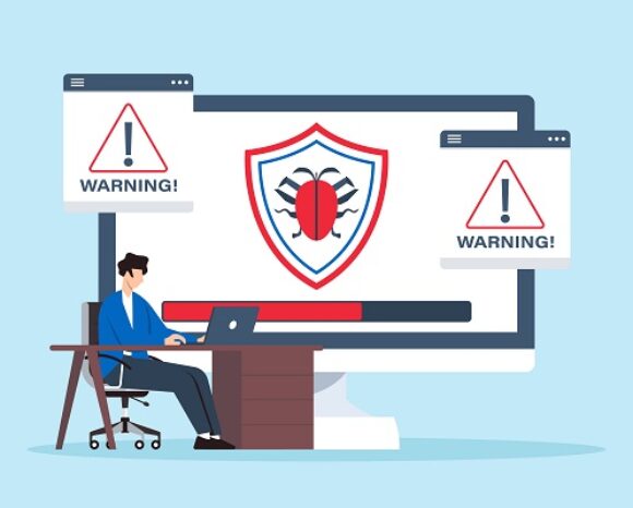 Malware auf Monitor mit Personal am Schreibtisch