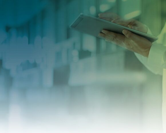 Ärztin mit Tablet vor Krankenhaus-Hintergrund